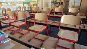 Blick in ein Klassenzimmer, die Stühle stehen auf den Tischen
