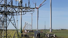 Blick auf einen großen Windpark mit Baustelle. 